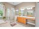 Bright bathroom featuring a walk-in shower, soaking tub, and large vanity with double sinks and counter space at 12801 Stanwyck Cir, Tampa, FL 33626