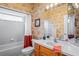 Bathroom featuring a vanity sink with traditional cabinets and a shower/tub combo with a decorative shower curtain at 12801 Stanwyck Cir, Tampa, FL 33626