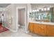 Bathroom featuring a vanity with a sink and mirror, with an open doorway to the toilet room at 12801 Stanwyck Cir, Tampa, FL 33626