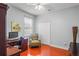 Bedroom featuring wood floors, a desk, and a reading chair with a window view at 12801 Stanwyck Cir, Tampa, FL 33626