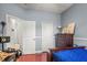 Spacious bedroom featuring wood floors, three doorways, and a dresser with a lamp at 12801 Stanwyck Cir, Tampa, FL 33626