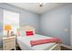 Bedroom with neutral paint, an accent pillow, and a nightstand with a lamp by the bed at 12801 Stanwyck Cir, Tampa, FL 33626