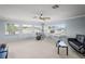 Large bonus room features a ceiling fan and multiple windows that provide lots of natural light at 12801 Stanwyck Cir, Tampa, FL 33626