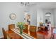 Dining room with hardwood floors, a vase of flowers, and view to kitchen at 12801 Stanwyck Cir, Tampa, FL 33626