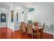 Dining room with hardwood floors, large windows, decorative lighting, and seating for six at 12801 Stanwyck Cir, Tampa, FL 33626