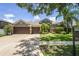 Charming single Gathering home with a three car garage, landscaped yard, and well-maintained lawn at 12801 Stanwyck Cir, Tampa, FL 33626