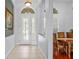 Bright foyer with tiled floor, arched doorway and decorative glass door leading to the dining room at 12801 Stanwyck Cir, Tampa, FL 33626