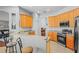 Kitchen features stainless steel appliances, light-colored cabinets, tan countertops and breakfast bar with seating at 12801 Stanwyck Cir, Tampa, FL 33626