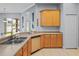 Bright kitchen with stainless steel sink, matching appliances and tan countertops and tile floors at 12801 Stanwyck Cir, Tampa, FL 33626
