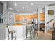 Well-lit kitchen featuring wooden cabinets, stainless steel appliances, and a breakfast bar for casual dining at 12801 Stanwyck Cir, Tampa, FL 33626