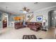 Wide open living area with a large leather sofa, tile floors, staircase, and bar stool seating at 12801 Stanwyck Cir, Tampa, FL 33626
