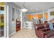 Open-concept living space with kitchen, breakfast bar, view to the backyard and comfortable seating at 12801 Stanwyck Cir, Tampa, FL 33626