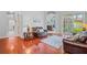 Warm living room with hardwood floors, leather furniture and sliding doors to the outdoor lanai at 12801 Stanwyck Cir, Tampa, FL 33626