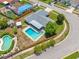 Aerial view showcases a home's pool, fenced backyard, mature landscaping, and neighborhood streets at 12879 112Th St, Largo, FL 33778
