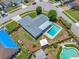 Aerial view showcases a home's pool, fenced backyard, mature landscaping, and neighborhood streets at 12879 112Th St, Largo, FL 33778