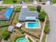 Aerial view of a home featuring a pool, fenced yard, and mature landscaping at 12879 112Th St, Largo, FL 33778