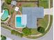 Aerial view of a home featuring a pool, fenced yard, and mature landscaping on a sunny day at 12879 112Th St, Largo, FL 33778