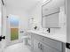 Bright bathroom with updated vanity, marble countertop, contemporary fixtures, and window view at 12879 112Th St, Largo, FL 33778