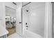 Stylish bathroom featuring white subway tile, updated fixtures, and bathtub with glass doors at 12879 112Th St, Largo, FL 33778