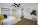 Cozy bedroom boasts wood floors, ceiling fan, closet space, and access to an ensuite bathroom at 12879 112Th St, Largo, FL 33778