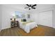 Charming bedroom featuring wood floors, a ceiling fan, and closet space for ample storage at 12879 112Th St, Largo, FL 33778
