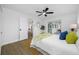 Bright bedroom featuring wood floors, a ceiling fan, and sliding glass doors to an outdoor patio at 12879 112Th St, Largo, FL 33778