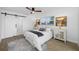 Comfortable bedroom features a ceiling fan, bright window, sliding barn door, and stylish nightstands at 12879 112Th St, Largo, FL 33778