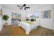 Light-filled bedroom with wood floors, ceiling fan, and sliding glass doors leading to a screened patio and pool at 12879 112Th St, Largo, FL 33778