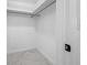 Walk-in closet features white marble-patterned tile floors and a hanging bar, maximizing storage space at 12879 112Th St, Largo, FL 33778