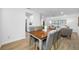 Inviting dining area with a wooden table, gray chairs, and view into kitchen and living room at 12879 112Th St, Largo, FL 33778