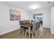 Inviting dining area with a wooden table, gray chairs, with sliding glass door to the backyard at 12879 112Th St, Largo, FL 33778