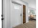 Bright entryway with wood flooring and custom wood trim detail on the front door leading to the living room at 12879 112Th St, Largo, FL 33778