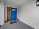 A modern blue front door with a decorative wood accent is displayed at 12879 112Th St, Largo, FL 33778