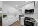 Modern kitchen with white cabinets, stainless steel appliances, and ample countertop space at 12879 112Th St, Largo, FL 33778