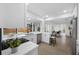Bright kitchen featuring white cabinets, stainless steel appliances, and a window overlooking the backyard at 12879 112Th St, Largo, FL 33778