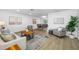 Open concept living room and dining area with wood-look floors and bright, neutral decor at 12879 112Th St, Largo, FL 33778