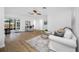 Bright living room featuring wood-look floors, glass sliding door, and comfortable furnishings at 12879 112Th St, Largo, FL 33778