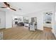 Living room open to kitchen with wood-look floors, and access to outdoor patio at 12879 112Th St, Largo, FL 33778