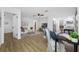 Open-concept living room featuring wood-look floors, neutral colors, and access to the kitchen at 12879 112Th St, Largo, FL 33778