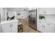 Open-concept living space transitioning from kitchen with stainless steel appliances at 12879 112Th St, Largo, FL 33778