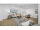 Bright living room features a neutral color palette, wood-look floors, and modern furnishings at 12879 112Th St, Largo, FL 33778