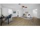 Open-concept living room features wood-look floors and an easy transition between rooms at 12879 112Th St, Largo, FL 33778