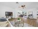 Open living room with modern ceiling fan, wood-look floors, and views of the backyard at 12879 112Th St, Largo, FL 33778