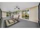 Screened patio with ceiling fans overlooking a pool and a fenced-in backyard at 12879 112Th St, Largo, FL 33778