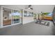 Screened patio with ceiling fans overlooking a pool and a fenced-in backyard at 12879 112Th St, Largo, FL 33778