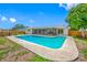 Backyard view featuring a large pool, screened-in patio, and fenced-in yard at 12879 112Th St, Largo, FL 33778