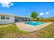 Backyard view featuring a large pool, screened-in patio, and fenced-in yard at 12879 112Th St, Largo, FL 33778