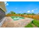 Sparkling backyard pool area with brick-paved patio and wood fence, ideal for relaxation and entertaining at 12879 112Th St, Largo, FL 33778