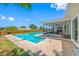 A refreshing backyard pool surrounded by a brick paver patio and screened-in lanai for outdoor relaxation at 12879 112Th St, Largo, FL 33778