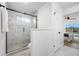 Bright bathroom with a glass enclosed shower featuring marble tile surround and modern fixtures at 12879 112Th St, Largo, FL 33778